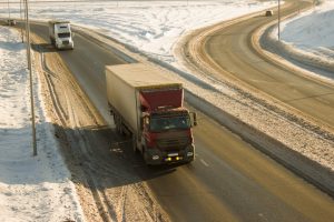Trucks on snowy winter highway road