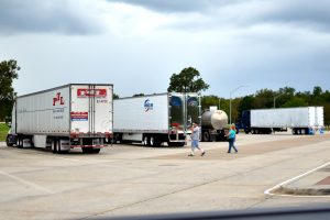 Truck Driver walking to truck at highway rest-stop, truck parking, Senate Bill Addresses Truck Parking