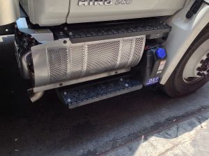 Hino truck with a selective catalytic reduction (SCR) system and diesel particulate filter (DPF), demonstrating the exhaust emission control technology