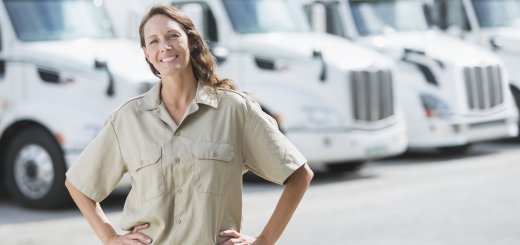 Woman standing in front of semi-trucks