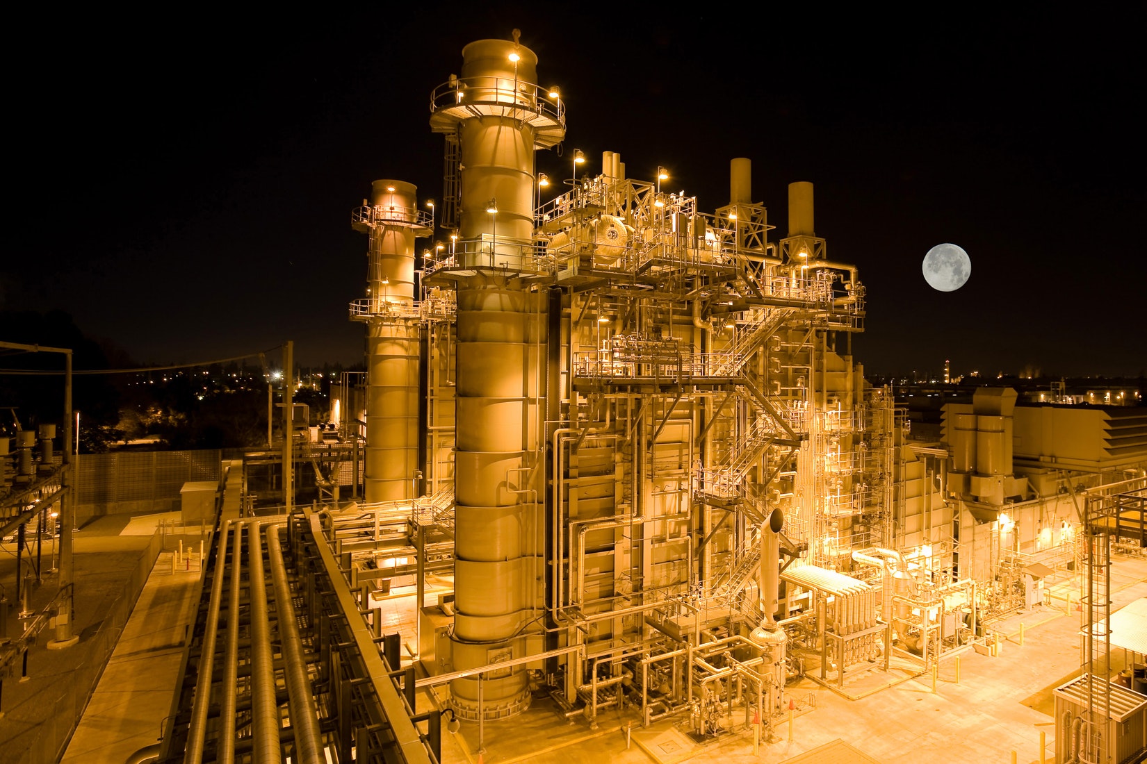 Natural gas plant at night with moon