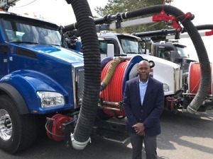 Archie Ferguson, City of Kirkland fleet manager, is shown with the city’s three Kenworth T880s, City Using Vacuum Trucks for Flooding