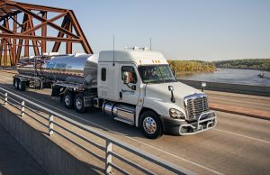 Liquid Trucking Truck going over bridge, Liquid Trucking Hikes Driver Pay