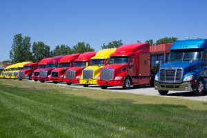 Line of colorful semi-trailer cabs, Report says trucking costs rose last year