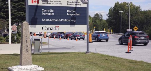 Cars pass a monument marking the border between the United States and Canada, Infrastructure Deal Includes Land Ports