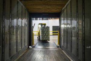 Forklift moving goods illustrating the vital role of LTL terminals in the freight industry