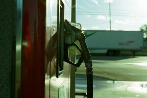 Trucking Industry Fuel Demand in 2024 symbolized by Gas station pump closeup in sunny day