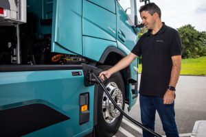 Man Charging Volvo FM Electric Truck at Charging Station